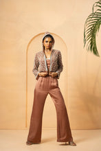 Load image into Gallery viewer, Intricate embelishment of pearls, cutdana, beads, and crystal stones on blouse , hoodie, and side of the pant.