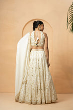 Load image into Gallery viewer, Intricate hand-embelishment of mirrors, pearls, sequin and cutdana beads. all over lehenga, blouse and dupatta border.