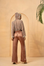 Load image into Gallery viewer, Intricate embelishment of pearls, cutdana, beads, and crystal stones on blouse , hoodie, and side of the pant.