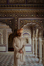 Load image into Gallery viewer, MUSHROOM RAW SILK SHERWANI WITH A COTTON SILK KURTA AND CHURIDAR AND OPTIONAL STOLE BELT AND WORKED JUTIS.