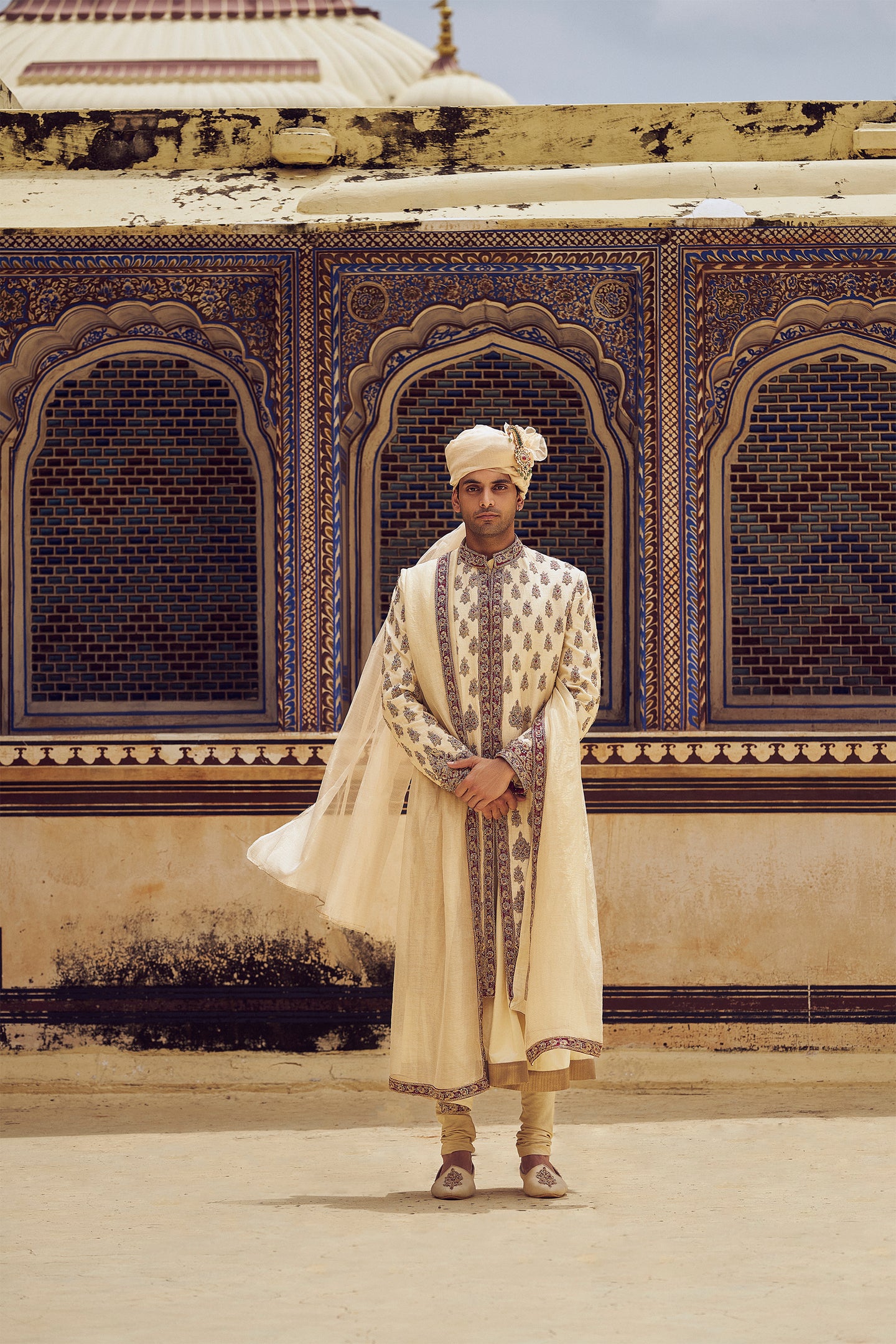 BEIGE RAW SILK SHERWANI WITH A COTTON SILK CHOGA AND CHURIDAR, WITH AN OPTIONAL STOLE AND JUTIS