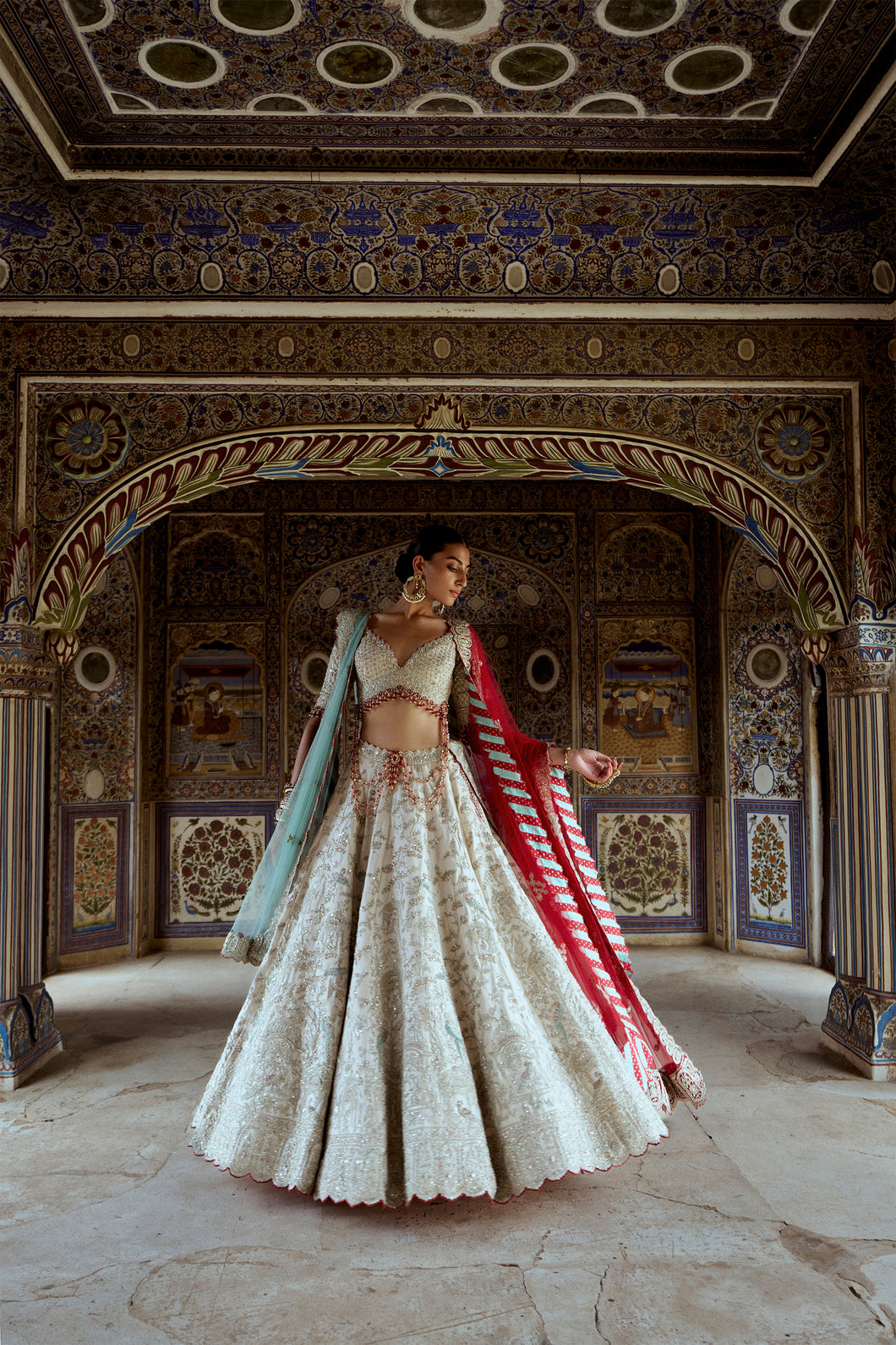 SILVER TISSUE LEHENGA CHOLI SET WITH AQUA NET DUPATTA AND AN OPTIONAL RED NET DUPATTA AND A HEAD VEIL WHICH CAN BE ORDERED SEPARATELY