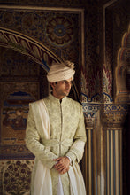 Load image into Gallery viewer, MINT GREEN RAW SILK SHERWANI WITH IVORY KURTA AND TROUSER WITH OPTIONAL WORKED STOLE BELT AND JUTIS.
