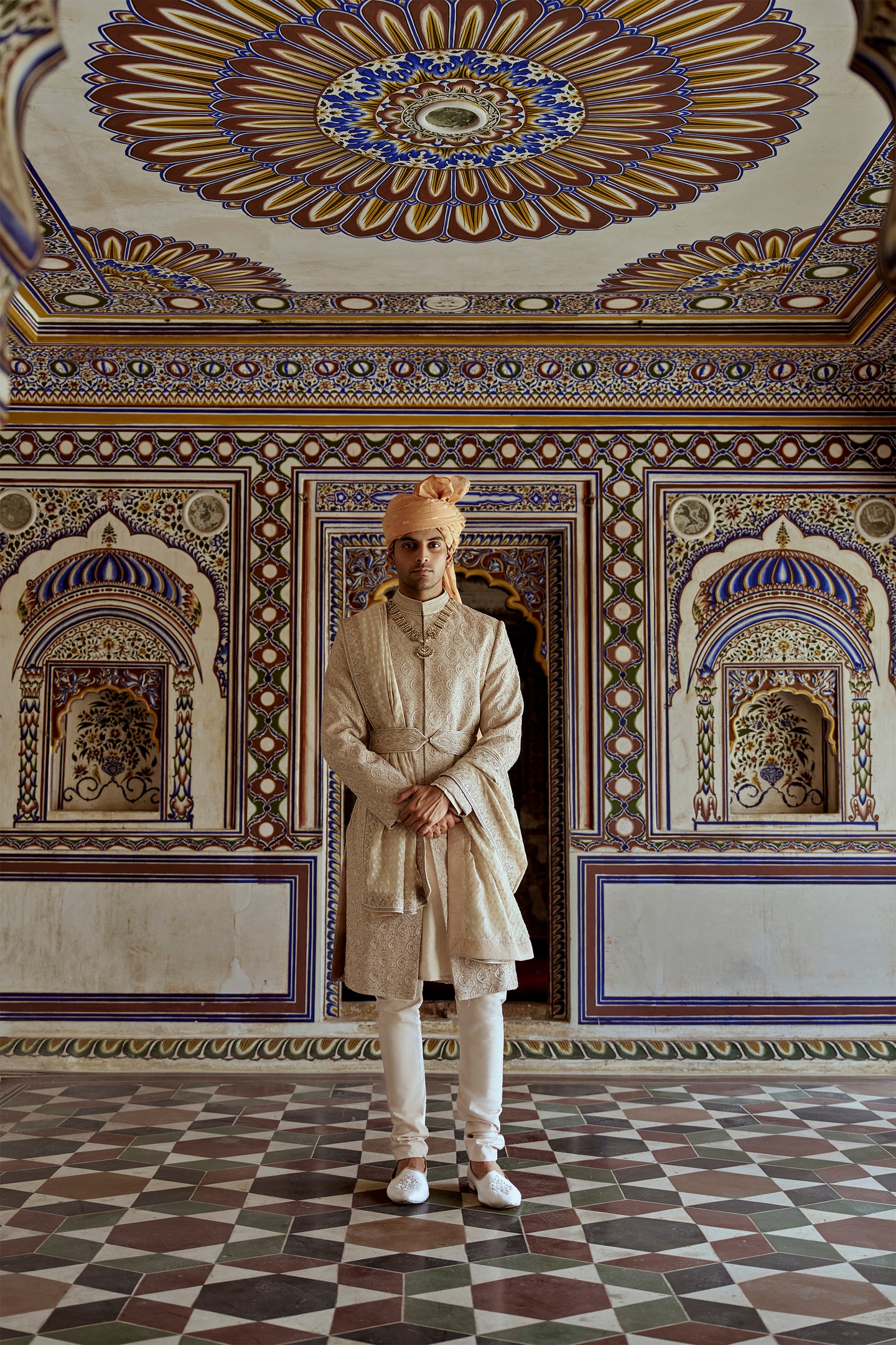 MUSHROOM RAW SILK SHERWANI WITH A COTTON SILK KURTA AND CHURIDAR AND OPTIONAL STOLE BELT AND WORKED JUTIS.