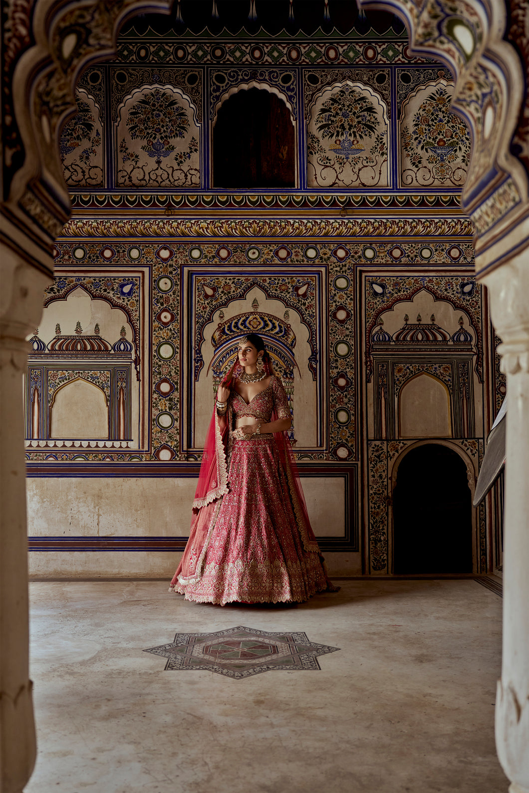 RED RAW SILK LEHENGA CHOLI WITH A NET DUPATTA AND AN OPTIONAL SECOND TISSUE  DUPATTA  WHICH CAN BE ORDERED SEPARATELY