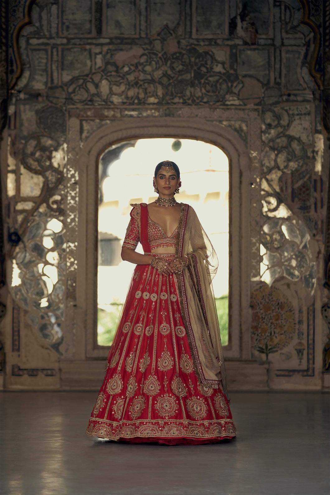 RED RAW SILK LEHENGA CHOLI WITH NET DUPATTA WITH AN OPTIONAL BEIGE NET DUPATTA AND WORKED BELT.