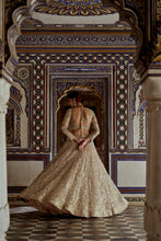 Load image into Gallery viewer, CHAMPAGNE GOLD NET LEHENGA CHOLI AND DUPATTA WITH AN OPTIONAL WORKED BELT AND HEAD VEIL.

