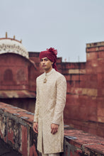 Load image into Gallery viewer, LIGHT BEIGE RAW SILK SHERWANI WITH KURTA AND CHURIDAR. IT COMES WITH AN OPTIONAL BELT, STOLE AND JUTIS
