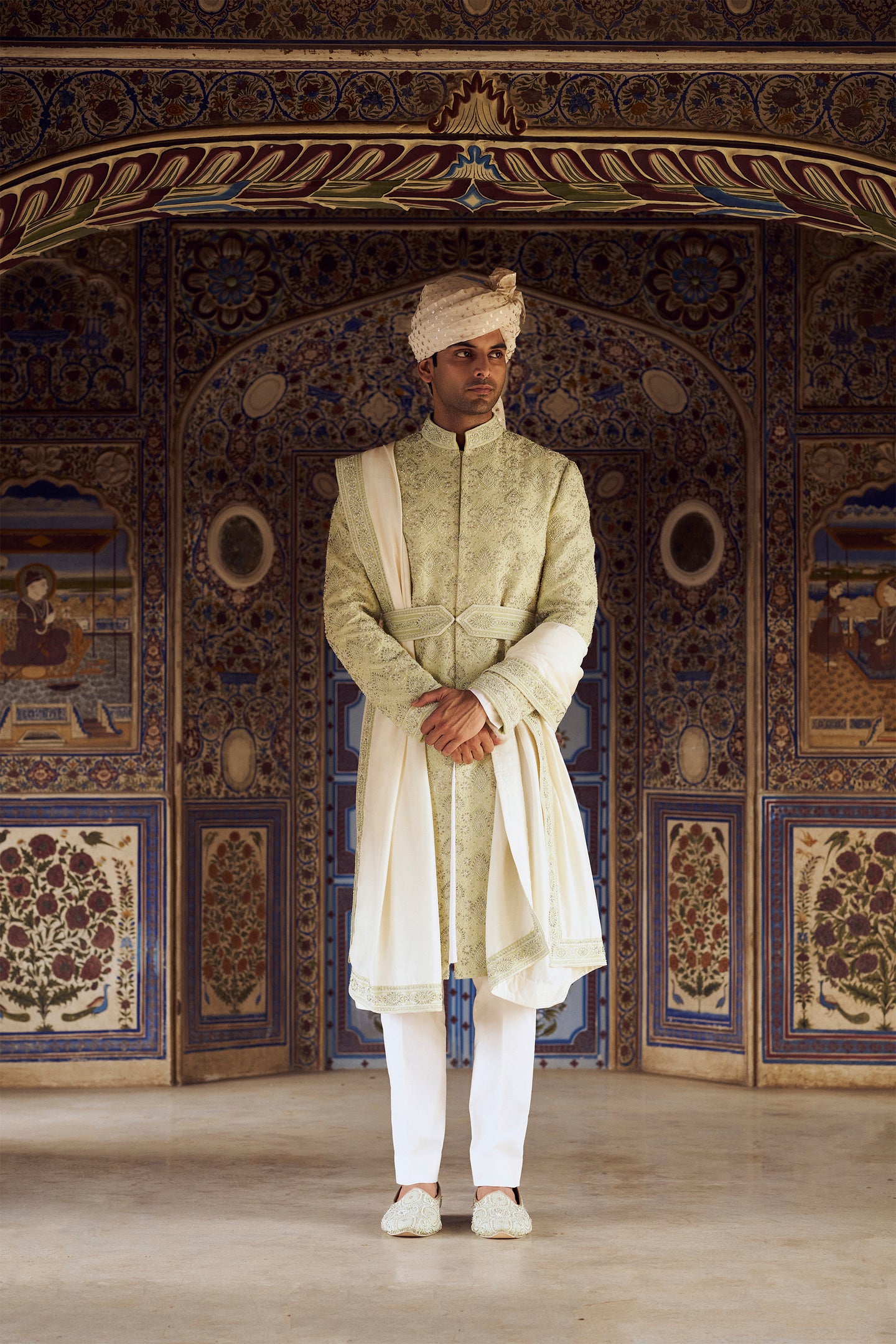 MINT GREEN RAW SILK SHERWANI WITH IVORY KURTA AND TROUSER WITH OPTIONAL WORKED STOLE BELT AND JUTIS.