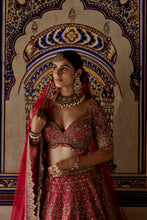 Load image into Gallery viewer, RED RAW SILK LEHENGA CHOLI WITH A NET DUPATTA AND AN OPTIONAL SECOND TISSUE  DUPATTA  WHICH CAN BE ORDERED SEPARATELY
