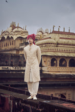 Load image into Gallery viewer, LIGHT BEIGE RAW SILK SHERWANI WITH KURTA AND CHURIDAR. IT COMES WITH AN OPTIONAL BELT, STOLE AND JUTIS
