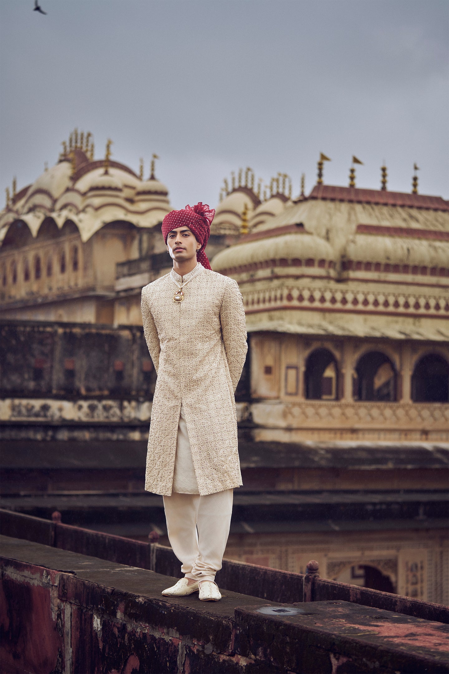 LIGHT BEIGE RAW SILK SHERWANI WITH KURTA AND CHURIDAR. IT COMES WITH AN OPTIONAL BELT, STOLE AND JUTIS