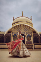 Load image into Gallery viewer, GOLD TISSUE LEHENGA CHOLI WITH A PEACH  TISSUE  DUPATTA AND AN OPTIONAL RED DUPTTA AND BELT WHICH CAN BE ORDERED SEPATATELY.
