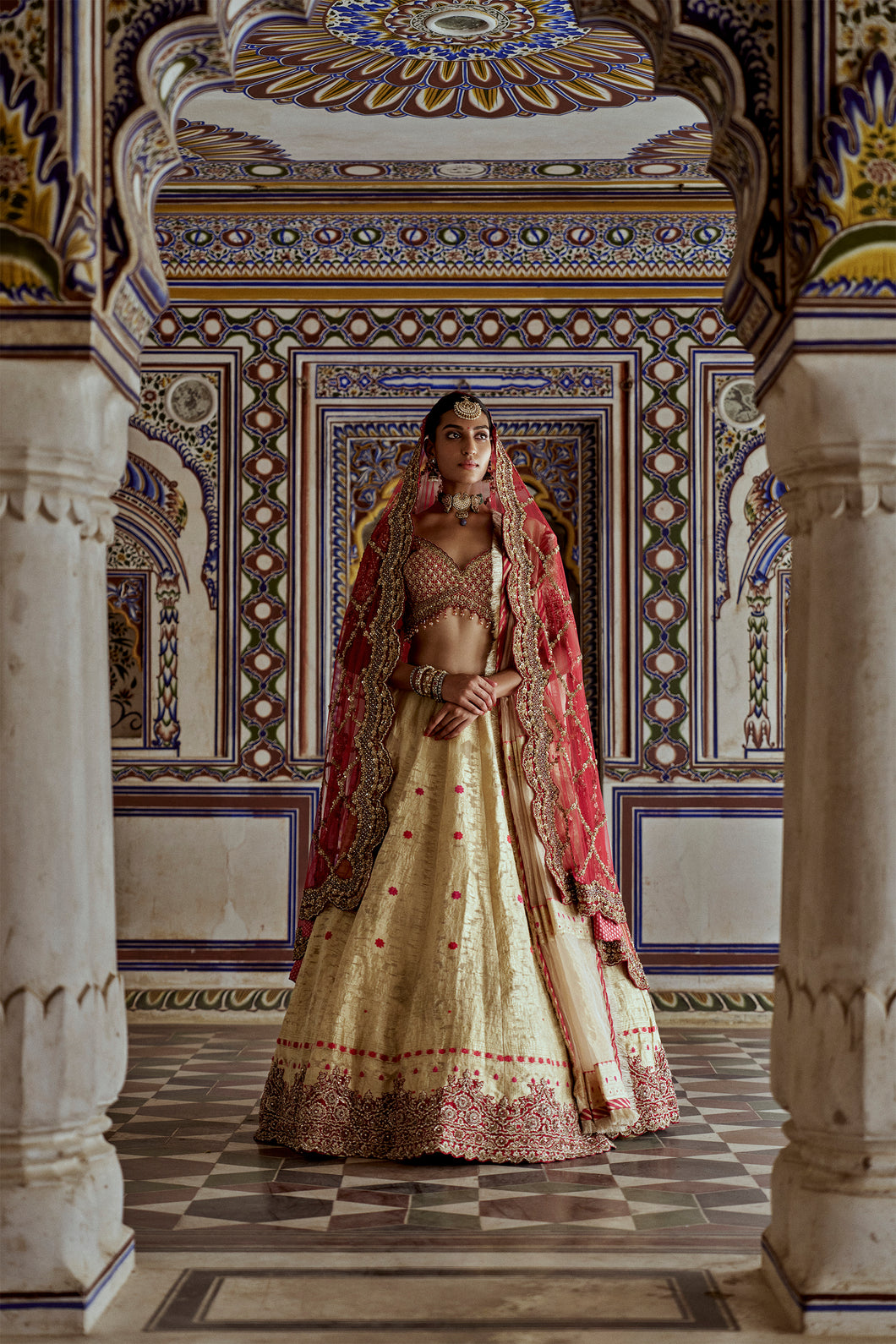 GOLD WOVEN BENARSI LEHENGA WITH RED BORDER AND RED RAW SILK CHOLI AND A RED NET JAAL DUPATTA AND AN OPTIONAL SECOND DUPATTA