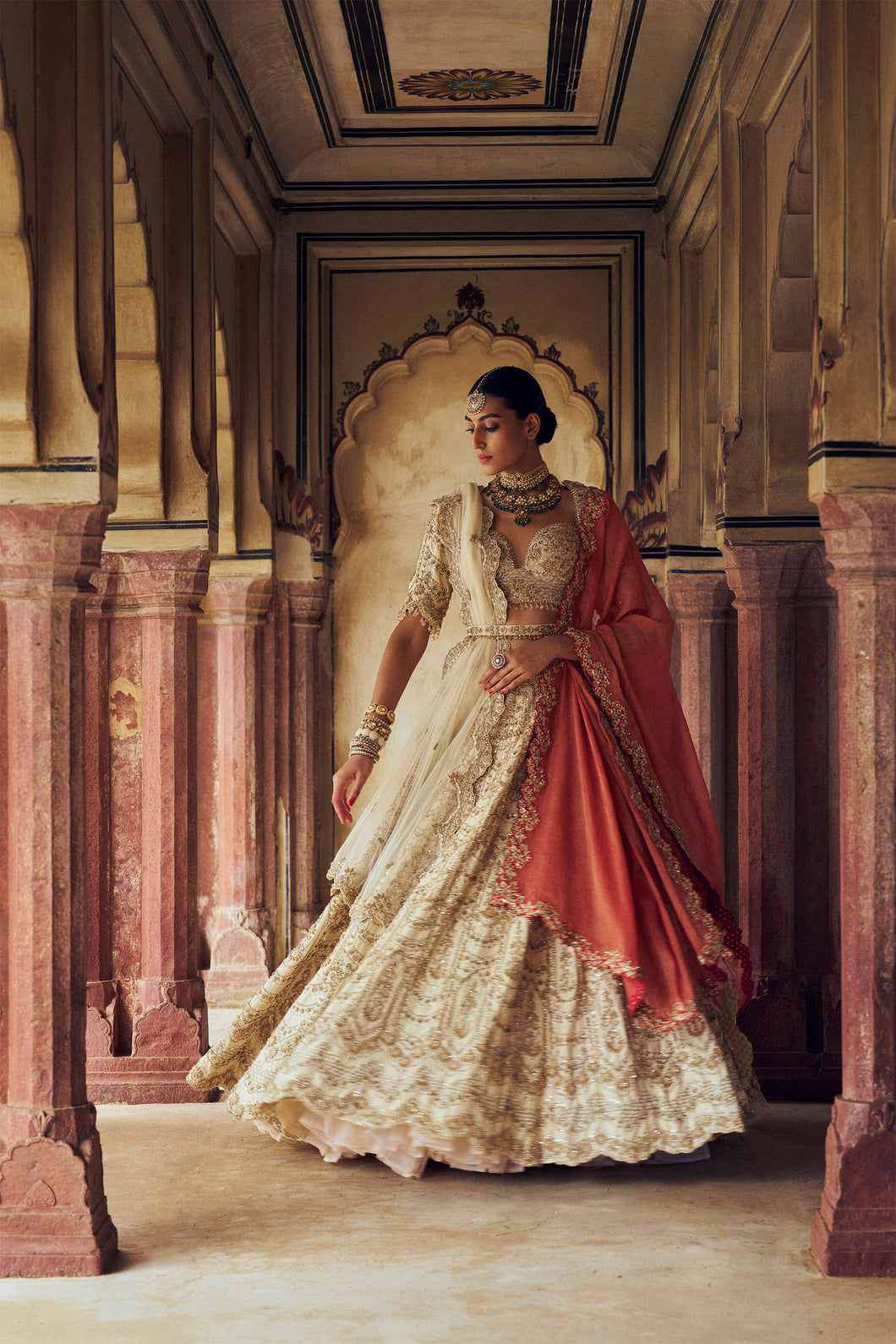 GOLD RAW SILK LEHENGA CHOLI WITH A NET DUPATTA ALONG WITH AN OPTIONAL SECOND DUPATTA AND BELT