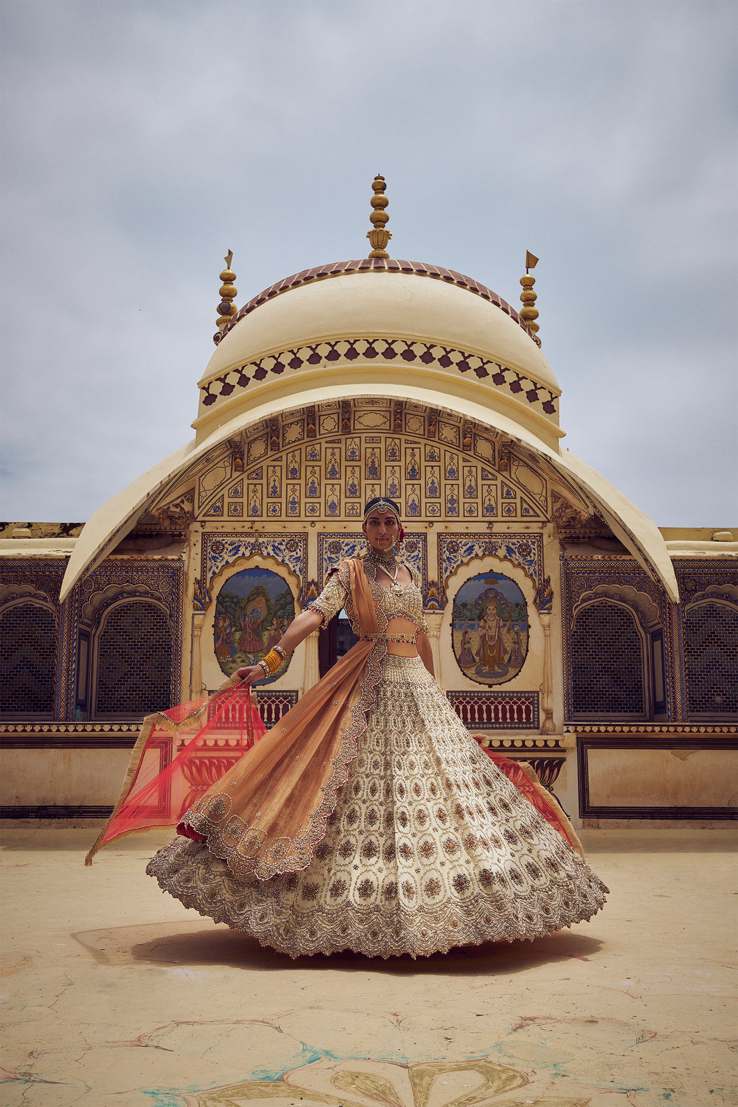 GOLD TISSUE LEHENGA CHOLI WITH A PEACH  TISSUE  DUPATTA AND AN OPTIONAL RED DUPTTA AND BELT WHICH CAN BE ORDERED SEPATATELY.