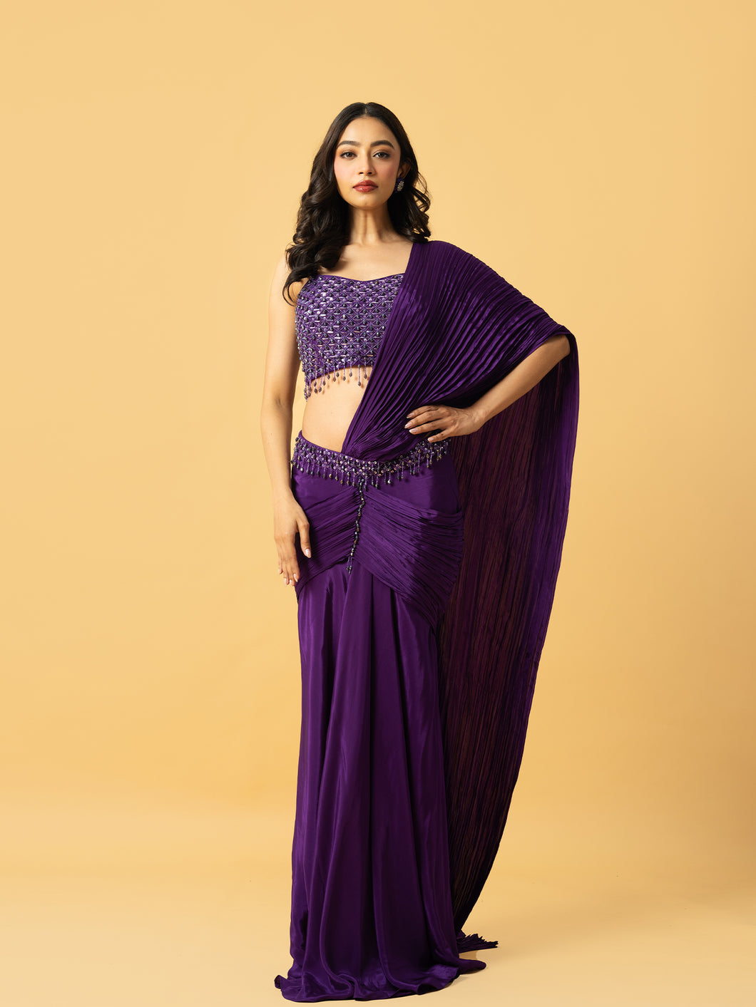 Violet crepe saree with hand embroidered sleeveless blouse